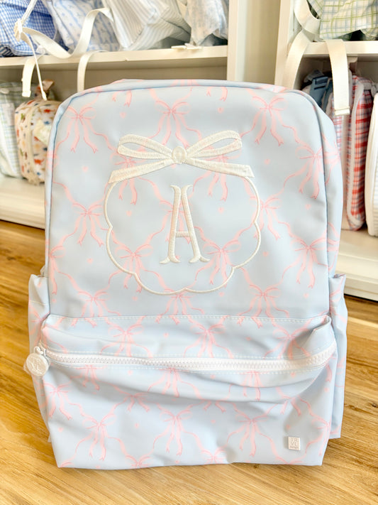 TRVL Eloise Bow Backpacker- Fishtail Monogram with Bow Crest